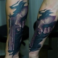Stunning looking colored realism style forearm tattoo of hand holding pistol