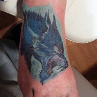 Stunning multicolored foot tattoo of werewolf head