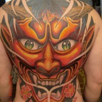 Stunning multicolored whole back tattoo of demonic mask with flowers