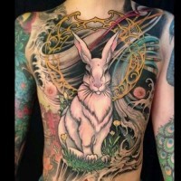 Stunning natural looking colored rabbit tattoo on chest stylized with various ornaments and flowers