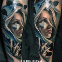 Stunning neo traditional style colored woman with hood and leaves tattoo on forearm