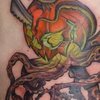 Stunning painted and colored corrupted pumpkin with knife and octopus tentacles tattoo on back
