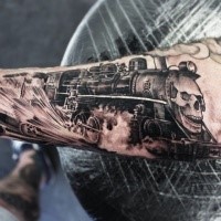 Stunning painted detailed arm tattoo of fast train with big skull