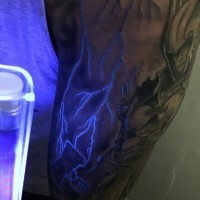 Stunning painted glowing lightning tattoo on arm