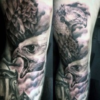 Stunning real black and white photo style large forearm tattoo of eagles