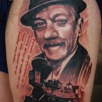 Stunning very beautiful thigh tattoo of train combined with man portrait and lettering
