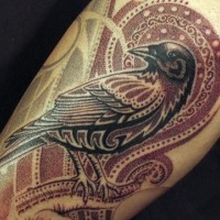 Stylized bird tattoo on arm