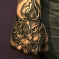 Super realistic cat with skull tattoo on hand