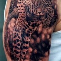 Super realistic jaguar on tree tattoo on shoulder