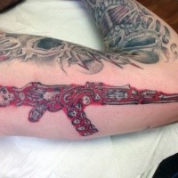 Superior original designed bone rifle tattoo on arm