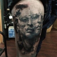 Surrealism style black and white thigh tattoo of alien face