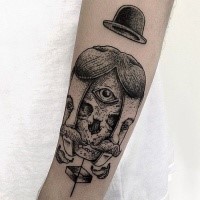 Surrealism style black ink arm tattoo of creepy human face