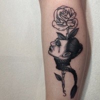 Surrealism style black ink colored leg tattoo of woman head with rose flower
