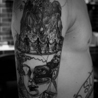 Surrealism style black ink shoulder tattoo of human face with creepy figures