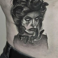 Surrealism style black ink side tattoo of Medusa face