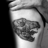 Surrealism style black ink side tattoo of animal skull with flowers