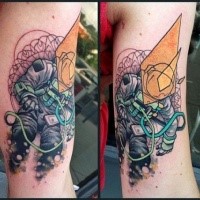 Surrealism style colored arm tattoo of astronaut with various ornaments