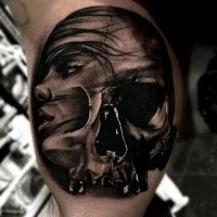 Surrealism style colored biceps tattoo of woman face with skull