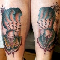 Surrealism style colored legs tattoo of human and woman faces
