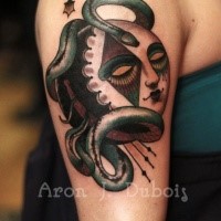 Surrealism style colored shoulder tattoo of creepy mask with snake and stars