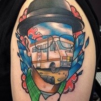 Surrealism style colored shoulder tattoo of man face stylized with bus