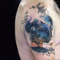 Surrealism style colored shoulder tattoo of woman face with stars