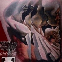 Surrealism style colored thigh tattoo of human with mask