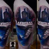 Surrealism style colored thigh tattoo of mystical face with human shaped figure