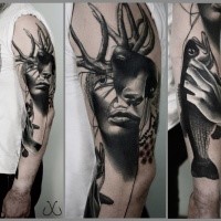 Surrealism style sleeve tattoo of woman face with deer horns and fish