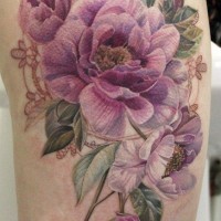 Sweet colored big realistic flowers tattoo on thigh
