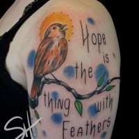 Sweet colored shoulder tattoo of bird on tree branch and lettering