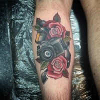 Sweet looking colored leg tattoo of modern camera with roses