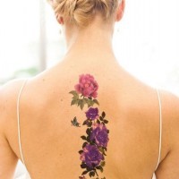 Sweet realistic looking various flowers with butterfly colored tattoo on back