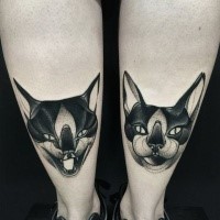 Symmetrical blackwork style painted by Michele Zingales cats tattoo on leg