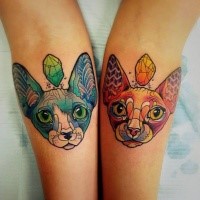 Symmetrical colorful cats tattoo on arm