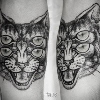 Symmetrical dot style arm tattoo of demonic cat with many eyes
