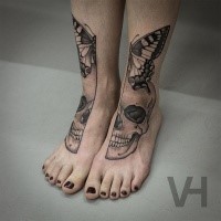 Symmetrical painted by Valentin Hirsch tattoo on legs of human skull and butterfly