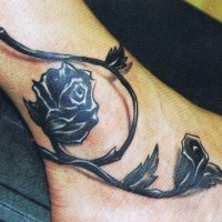 Black rose tattoo on hand