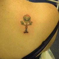 Le tatouage d'un mec extra-terrestre avec le signe V sur l'épaule