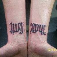 Ambigram luck and love on both wrists