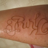 Ambigram tattoo made with white ink