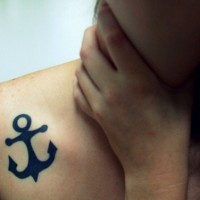 Black anchor tattoo on collarbone