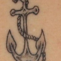 Dirty old anchor with rope tattoo close view