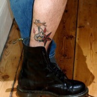 Semplice ancora con la stella tatuate sulla gamba