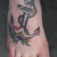 Big anchor tattoo in colour on feet
