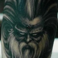 Scandinavian evil deity face tattoo