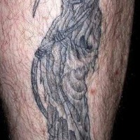 Le tatouage de la Faucheuse sur la jambe