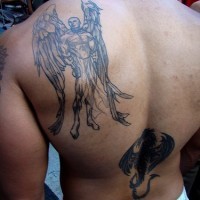 Half naked male angel tattoo on back
