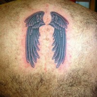 Black wings tattoo on hairy back