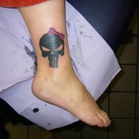 Skull with bow ankle tattoo